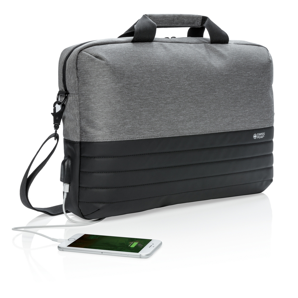 Torba na laptopa 15,6" Swiss Peak, ochrona RFID Torba na laptopa 15.6" z ochroną RFID, wewnątrz kieszeń na tablet oraz kieszeń na portfel i paszport z ochroną RFID, zintegrowany port USB do ładowania (power-bank nie jest dołączony), kieszeń na zamek błyskawiczny z tyłu oraz pasek do zamocowania na walizce